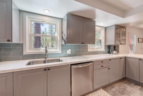 a kitchen with white cabinets and a sink at Cozy Cabin 5 Min Walk to Lake Tahoe Hot-Tub Excellent Location in Tahoe Vista