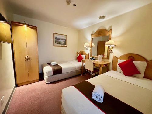 Postel nebo postele na pokoji v ubytování Palladium Suites Hotel