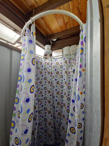 a shower with a shower curtain in a bathroom at Otto’s House in Guatemala