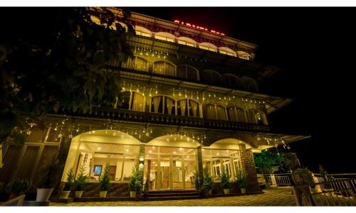 a lit up building with christmas lights on it at Carmel Top Munnar in Munnar