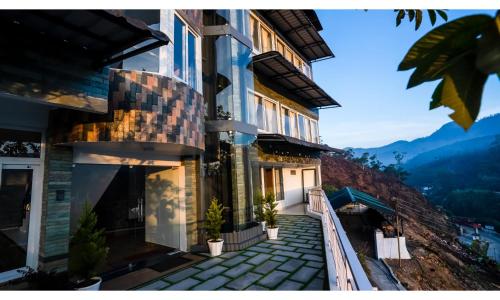 a house with a staircase leading up to it at Carmel Top Munnar in Munnar