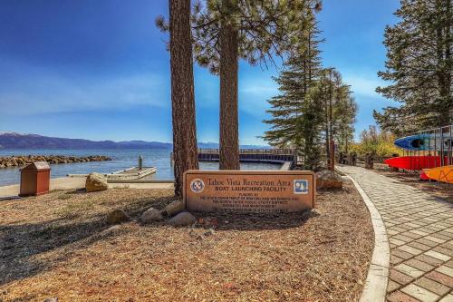 a sign in front of a lake with trees at Cozy Cabin 5 Min Walk to Lake Tahoe Hot-Tub Excellent Location in Tahoe Vista