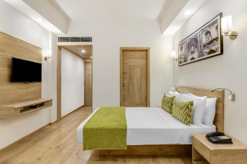 a bedroom with a bed and a flat screen tv at Lemon Tree Premier 1, Gurugram in Gurgaon