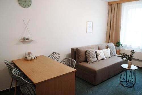 a living room with a couch and a table at Apartmány KiRi in Kyjov