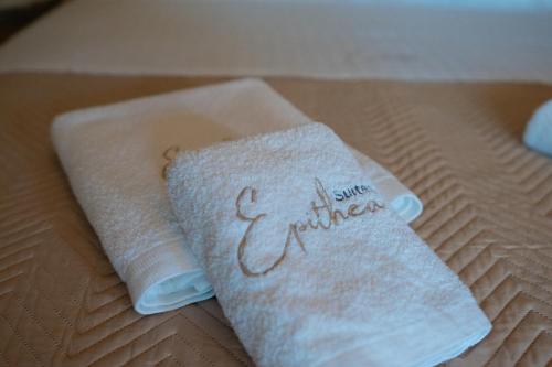 a pair of towels sitting on top of a bed at Epithea Suites Kythnos Keli in Kithnos