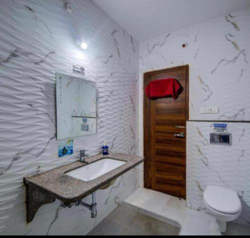 a bathroom with a sink and a toilet at White Camel companies in Hyderabad