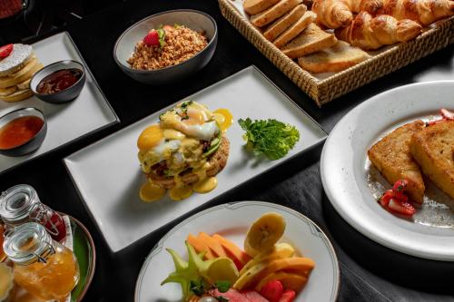 a table topped with plates of food and other foods at W15 Glenfall Nuwara Eliya in Nuwara Eliya