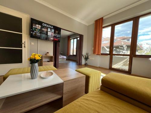 a living room with a couch and a table at Rio Sunny 2BDR Apt near NDK - Metro - non-stop paid public Parking in Sofia