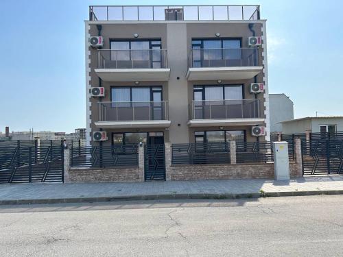 a tall building with a lot of windows at Studios and Apartments Pomorie in Pomorie