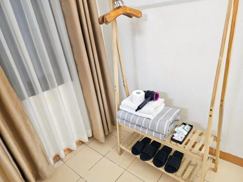 a room with a towel rack and a curtain at Especen Hotel in Hanoi