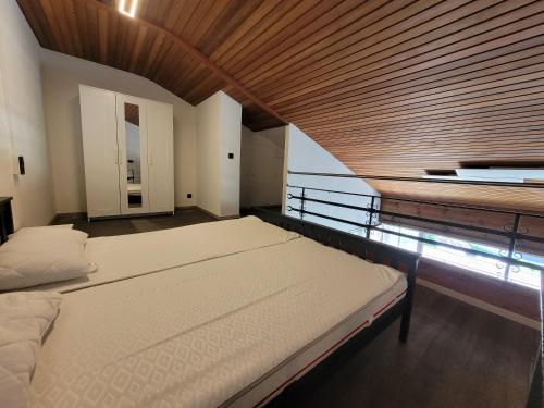 a bedroom with two beds and a wooden ceiling at Fewo Alpenblick | Pool | Bergblick in Berchtesgaden