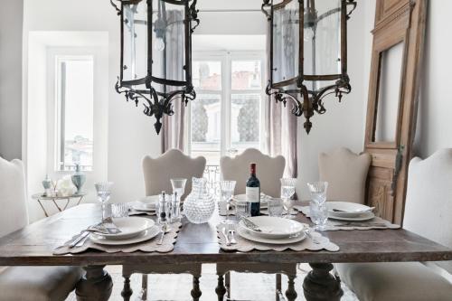 a dining room with a table with plates and glasses at Royal penthouse, comfort and luxury in Cannes