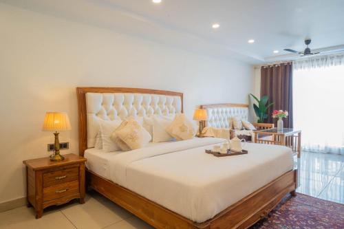 a bedroom with a large bed and a window at Perfectstayz Premium Mokshada Suites in Mussoorie