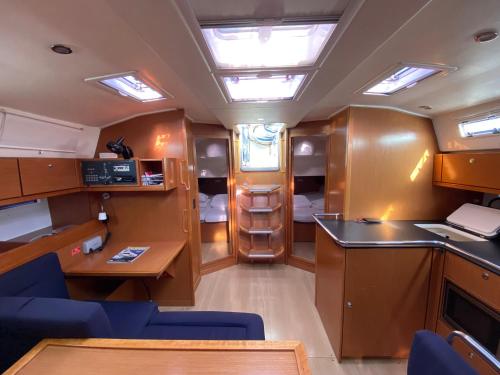a small kitchen and dining area of an rv at Bavaria 45 Cruiser Prive huur incl. schipperservice in Sukošan