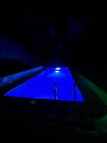 a dark room with a blue light in the dark at DOM V CHIMGANE in Kyzyldzhar