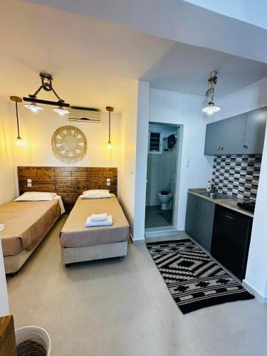 a small room with a bed and a kitchen at Elenis Studios&Apartments in Masouri