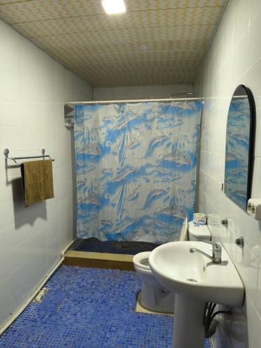 a bathroom with a toilet and a sink at DOM V CHIMGANE in Kyzyldzhar