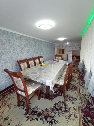 a dining room with a table and chairs at DOM V CHIMGANE in Kyzyldzhar