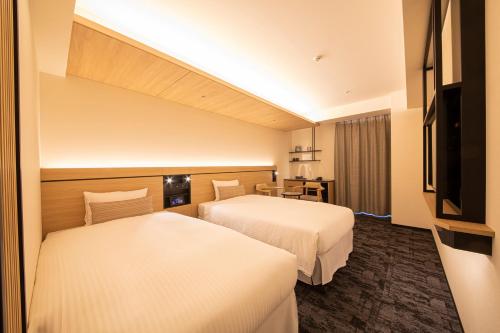 Ένα ή περισσότερα κρεβάτια σε δωμάτιο στο Hotel Keihan Kyoto Ekiminami
