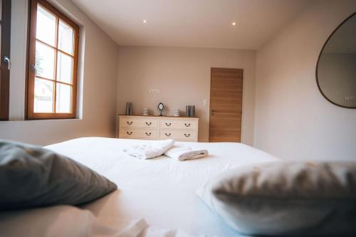a bedroom with two white beds and a mirror at Le Gué • Élégance fonctionnelle • Parking simple in Saint-Maur