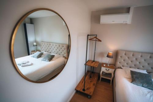 a bedroom with a large mirror and a bed at Le Gué • Élégance fonctionnelle • Parking simple in Saint-Maur