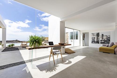a living room with a desk with a laptop on it at Finca el Rincón de Lanzarote in Tías