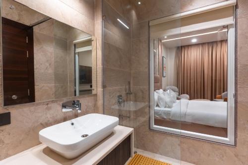 a bathroom with a sink and a mirror at Mountoria Retreat Bhimtal- by Leisure Hotels Group in Bhīm Tāl