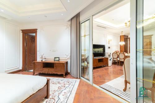 a bedroom with a bed and a sliding glass door at Luxe Paradise Suite Hotel Trich Sai in Hanoi
