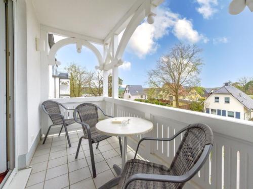 a white balcony with chairs and a table on it at Villa Dornbusch in Binz - WG08 mit Balkon, WLAN und Tiefgarage in Binz