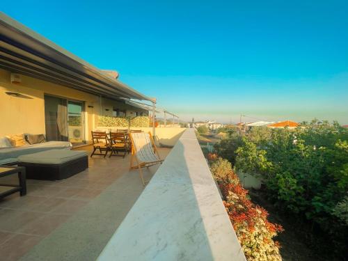 a balcony of a house with a view of the ocean at Casa Maria-Anneta in Kalyves Poligirou
