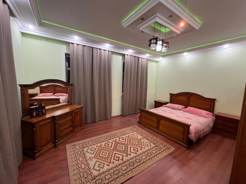 a bedroom with two beds and a mirror at Eden Guest House in Corat