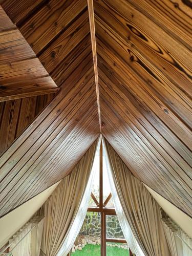 a wooden ceiling in a tent with a window at Nhà Sói Homestay Da Lat in Da Lat