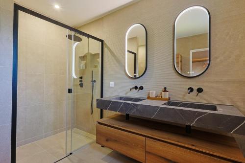 La salle de bains est pourvue d'un lavabo, de deux miroirs et d'une douche. dans l'établissement Villa Medea -Beautiful family villa, à La Croix-Valmer