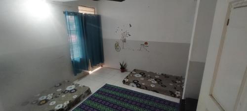 a small room with a bed and a window at Traveler House in Dimāpur