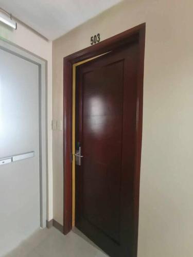 a wooden door with the numbers on it in a room at Spacious Studio Apartment B503 in Manila
