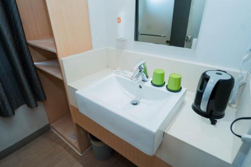 a bathroom with a white sink and a mirror at Go Hotels Iligan in Iligan City