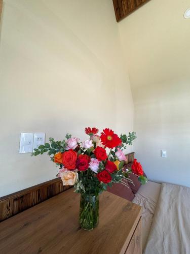 a vase of flowers on a table in a room at Nhà Sói Homestay Da Lat in Da Lat