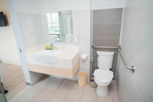 a bathroom with a white sink and a toilet at Go Hotels Iligan in Iligan City