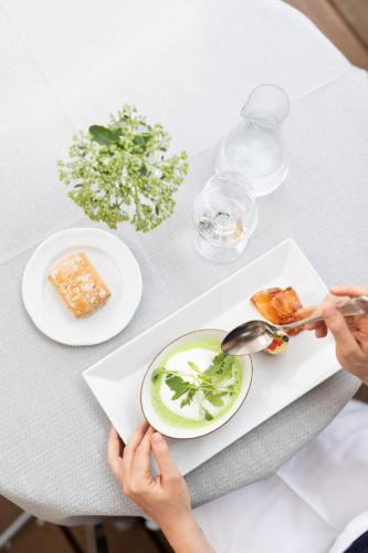 a person sitting at a table with a plate of food at Weinlandhof in Gamlitz