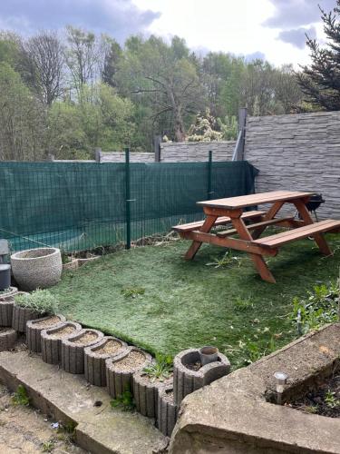 a wooden picnic table sitting on top of a yard at Ubytování Mája in Liberec