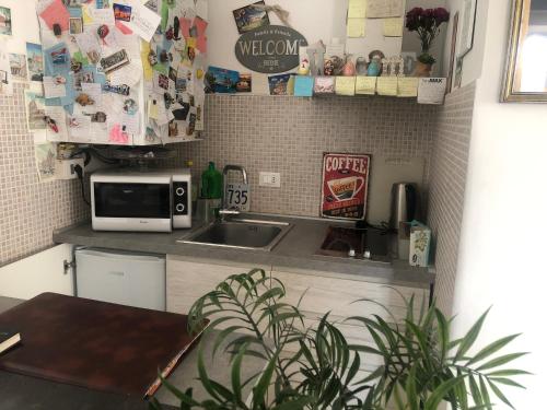 a kitchen with a sink and a microwave at My Bed Vatican Museum in Rome