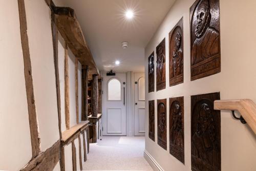 a hallway with wood paneled walls and a white door at BULL Burford in Burford