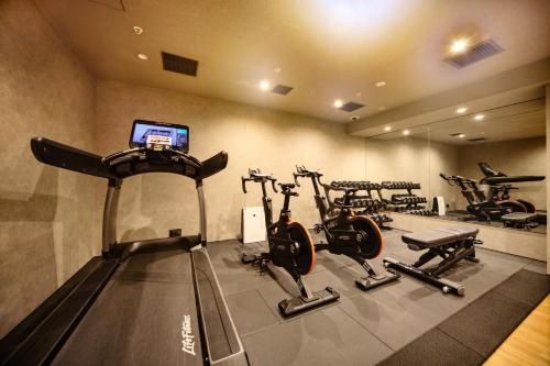 a gym with several exercise bikes in a room at The Royal Park Canvas - Kyoto Nijo in Kyoto
