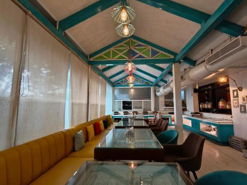 a dining room with a couch and a table at Hotel Heritage 2001, Nagpur in Nagpur
