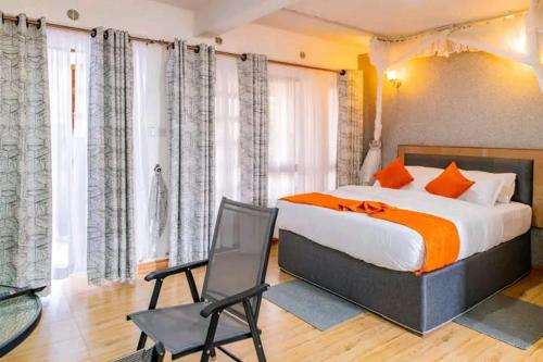 a bedroom with a king sized bed and a chair at Naivasha Wonderland Resort in Naivasha