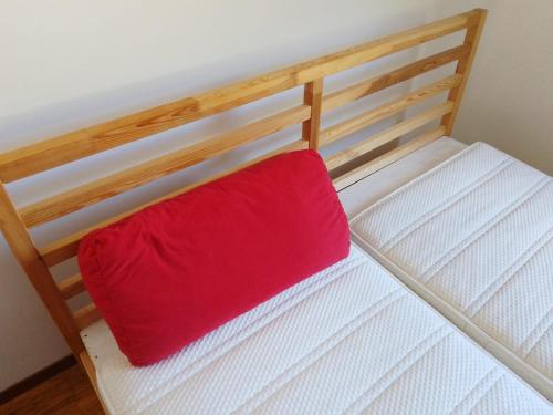 a red pillow sitting on top of a bunk bed at Castle-View Bellinzona in Bellinzona