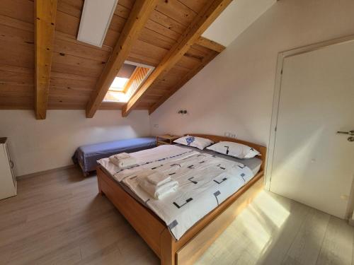 a bedroom with a large bed in a attic at Nortra apartment in Tolmin