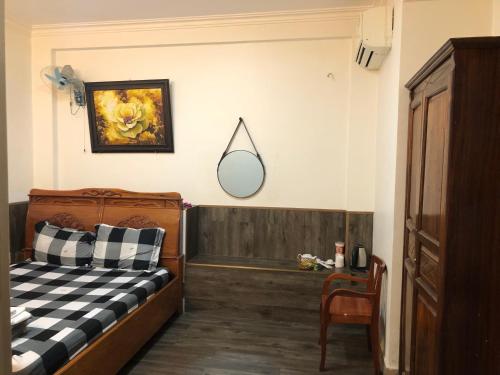 - une chambre avec un lit et un miroir mural dans l'établissement Khách sạn thái bảo, à Thôn Mỹ Phước