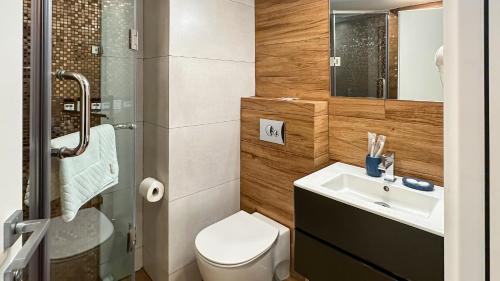 a small bathroom with a sink and a toilet at Silver 39 Corner Hotel in Tbilisi City