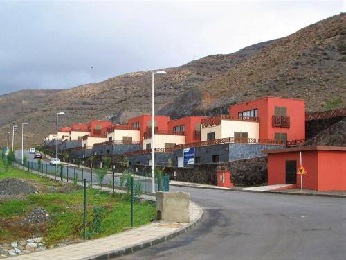 a street with a building on the side of a hill at Belvilla by OYO Holiday home in Jand a in Morro del Jable